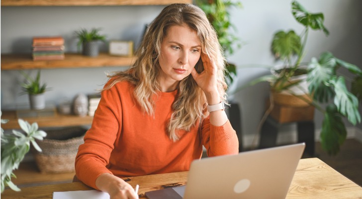 A woman reviews ways to lower her adjusted gross income (AGI), including contributing to certain retirement accounts.