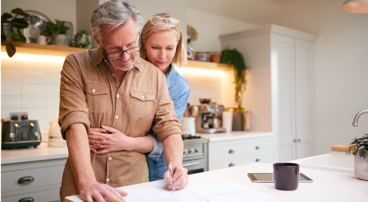 A couple signs documents purchasing AD&D insurance.