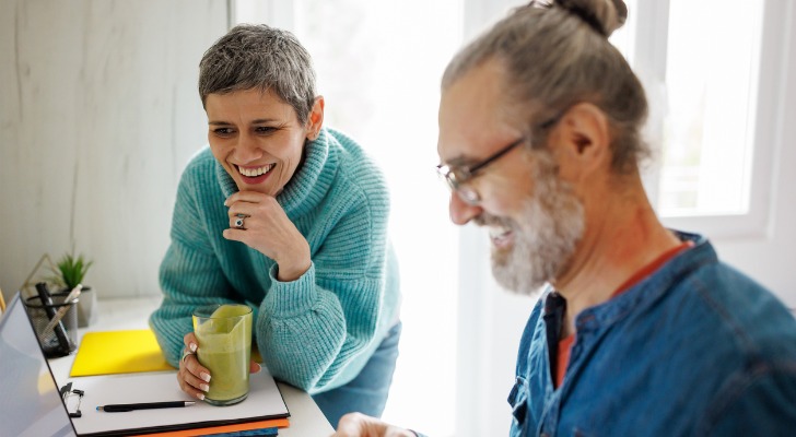 A couple researching low-risk retirement investments.