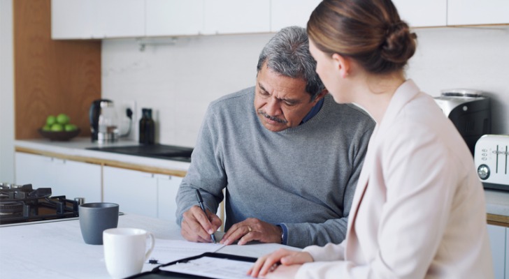 A senior reviews and signs a will in New York.