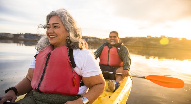 A retired couple enjoys a paddle in their kayak.