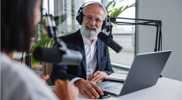 A man and woman record a podcast.