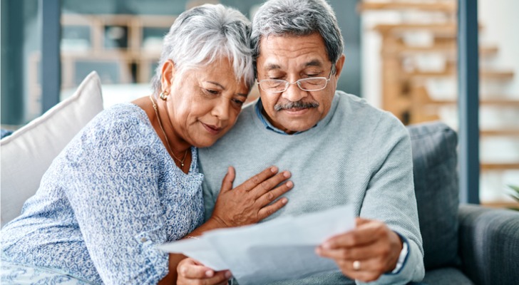 A couple reviews the costs of nursing home and long-term care insurance.