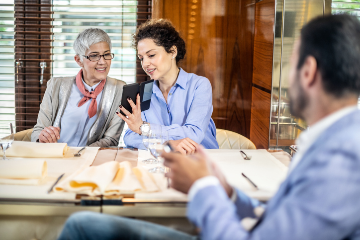A mother and daughter meeting with a financial advisor to help them manage their sudden wealth.