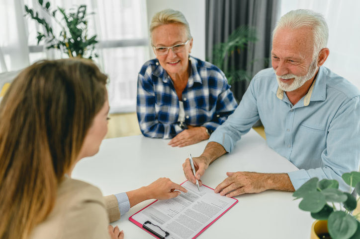 A senior couple signing a power of attorney in Illinois.