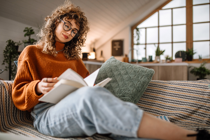 A woman reading a finance book for professional stock traders.