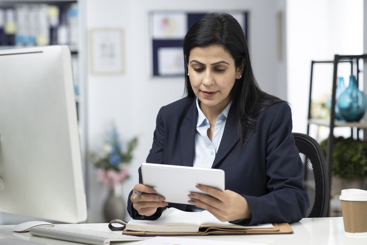 A woman searching online for a financial planner job.