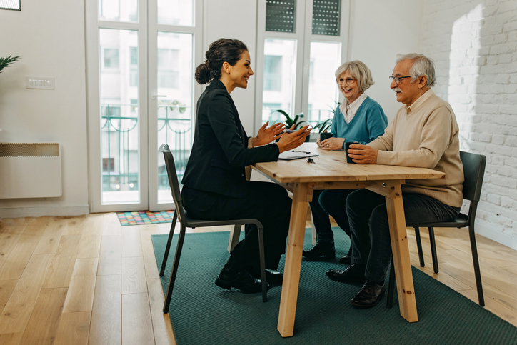 A senior couple meeting with a lawyer to discuss getting a power of attorney in Illinois.