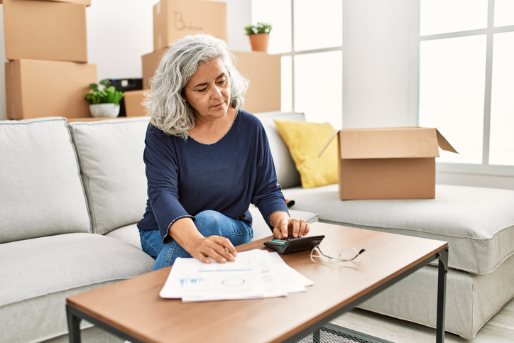 A woman calculating how much a tax-deferred annuity can pay her in retirement.
