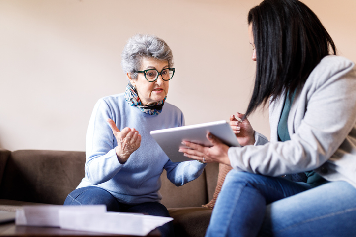 A daughter reviewing a power of attorney for her mother.