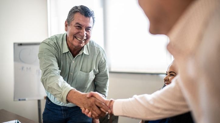 An employee shakes hands with his boss after submitting his retirement letter.