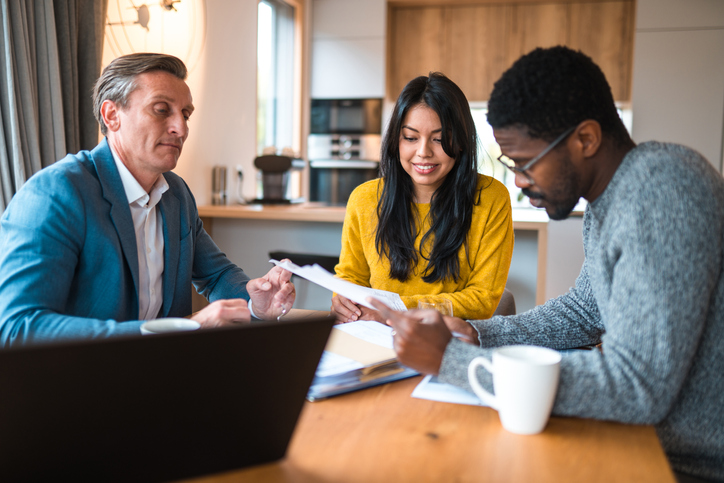 Clients meeting with a financial advisor to discuss life insurance options.