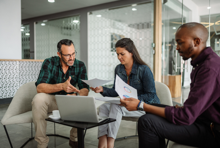 Financial advisors reviewing a book of business for sale.