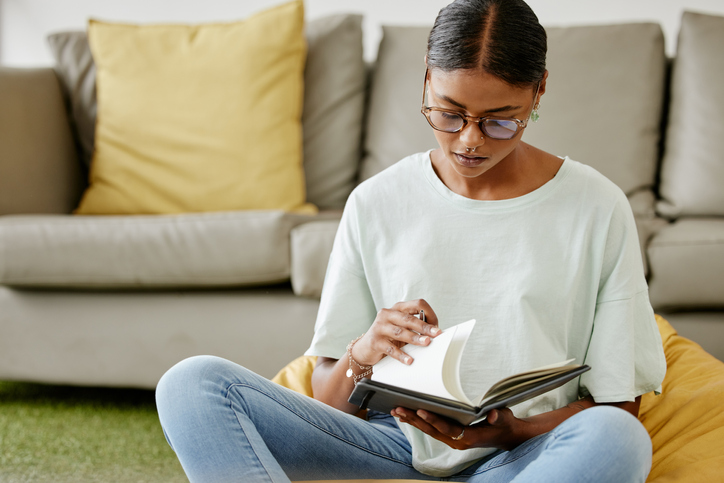 A woman reading a book about stock trading.