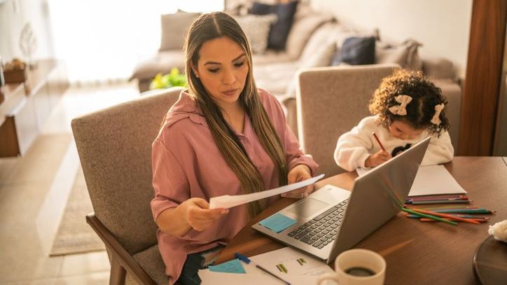 A woman calculates her estimated taxes that she makes each quarter to avoid underpayment penalties.