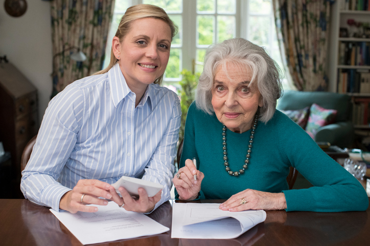 A mother and daughter preparing an estate plan to help lower estate taxes in Oregon.