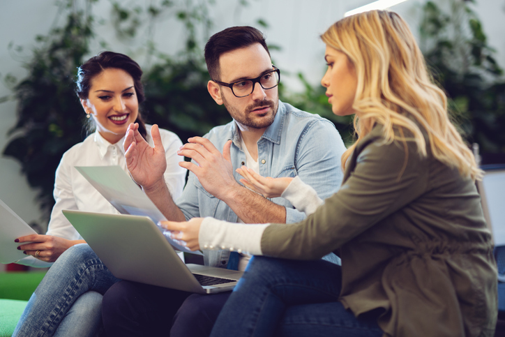 A couple meeting with an advisor to discuss the differences between getting revocable and irrevocable trusts in California.