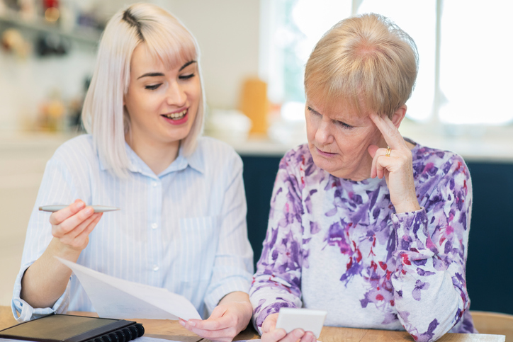 A senior creating a will with her daughter.