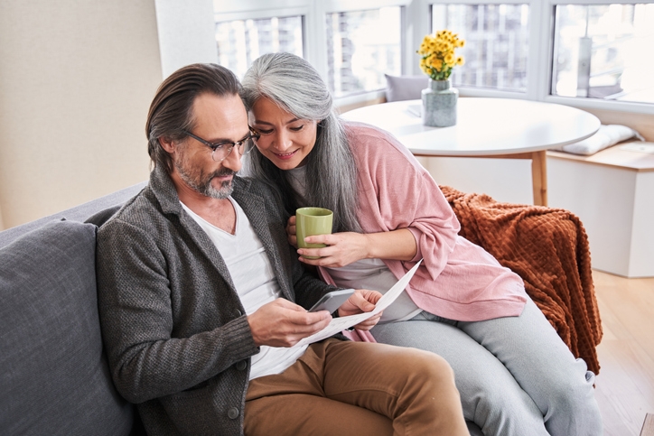 A couple in their prime earning years reviewing their consolidated 401(k) plan.