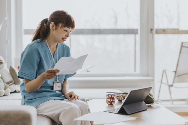 A nurse reviewing her financial plan with an advisor in a video meeting.