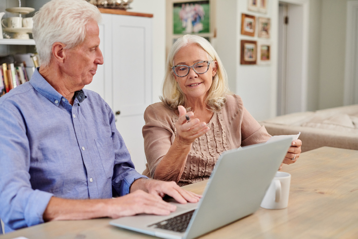 A senior couple reviewing their retirement budget.