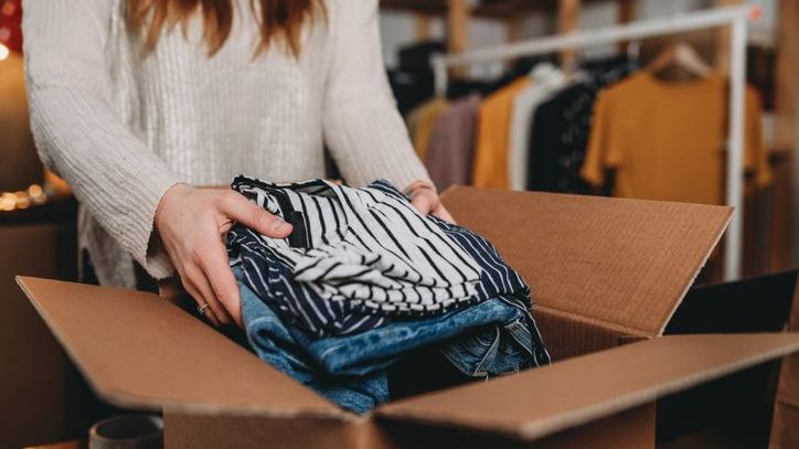 A woman packs away items that won't be for sale in an upcoming estate sale.