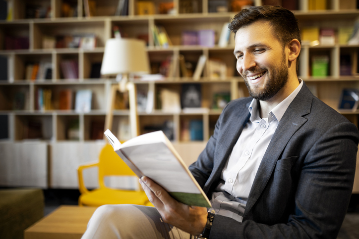 A financial advisor reading an investment book.