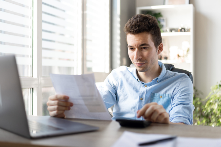 A taxpayer reviewing the federal income tax brackets to calculate how much he owes in the graduated income tax system.