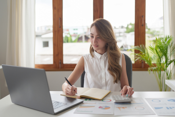 A woman researching strategies to negotiate for equity in her startup.