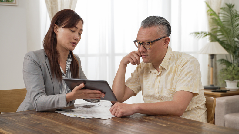 A financial advisor showing a nurse different options for his financial plan.