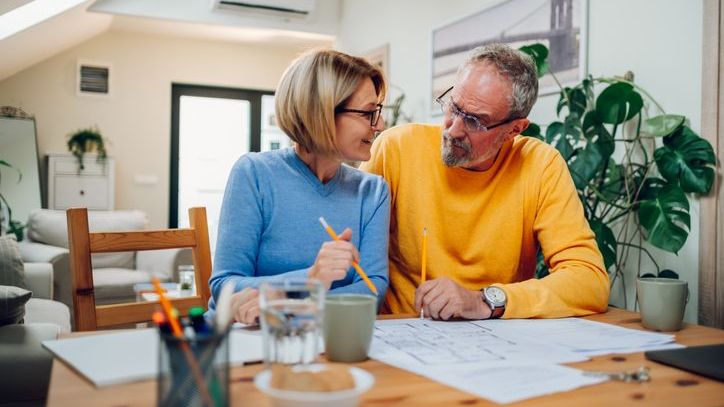 A couple looks over the plans for their home renovation project.
