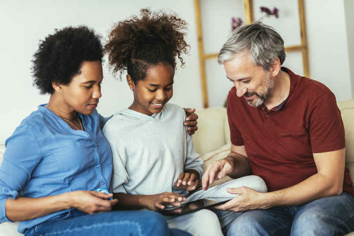 Parents showing their daughter the home they purchased with a low mortgage rate.