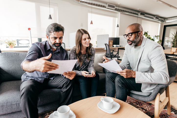 A financial advisor explaining to clients how cost basis is verified.