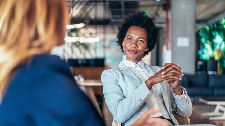 A financial advisor meets with a client in her office.