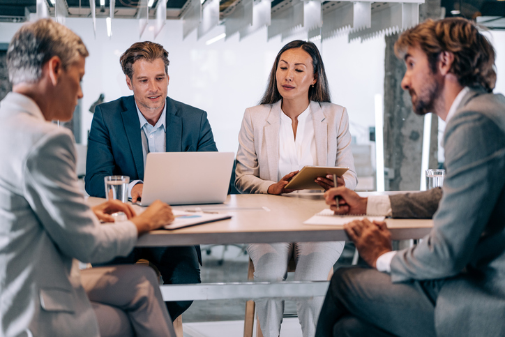 Financial advisors discussing wealth management tools to help attract prospective clients to their firm.