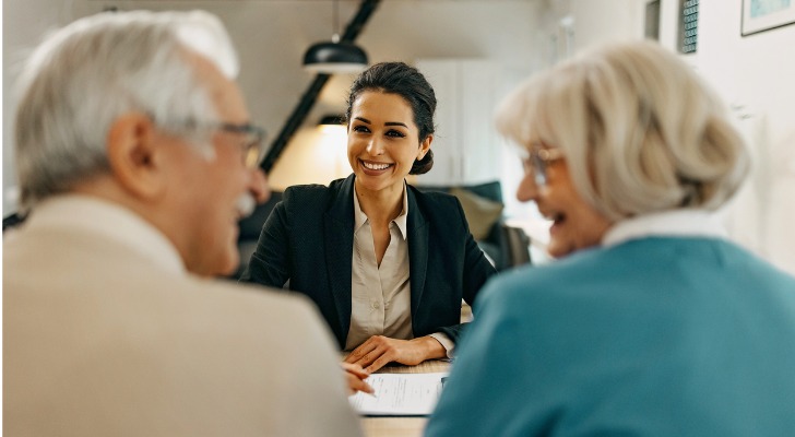A retired couple meets with their financial advisor to talk about the tax impact of their RMDs.