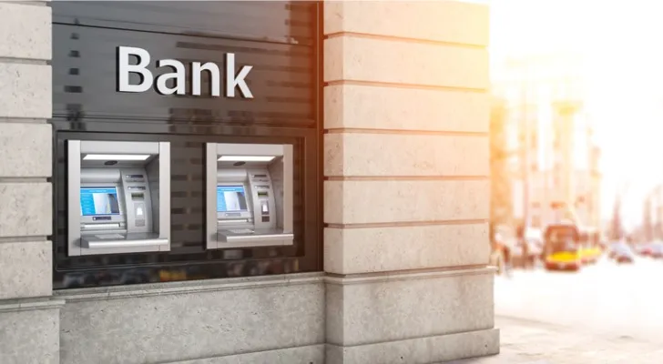A picture of ATMs outside of a bank.