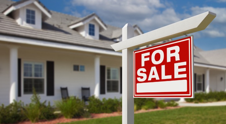 A for sale sign hangs in front of a home that is being sold as part of a divorce.