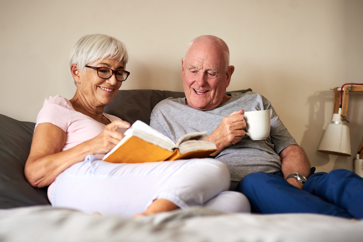 A senior couple reading a book about transfer on death deeds.