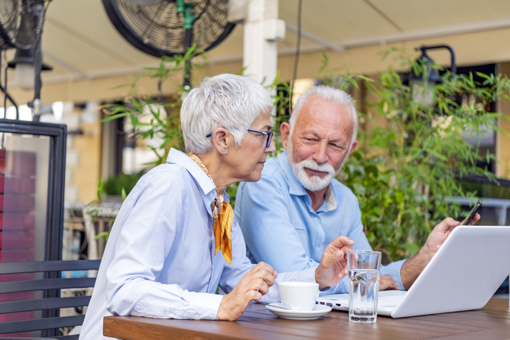 A senior couple reviewing their mutual fund retirement investments.