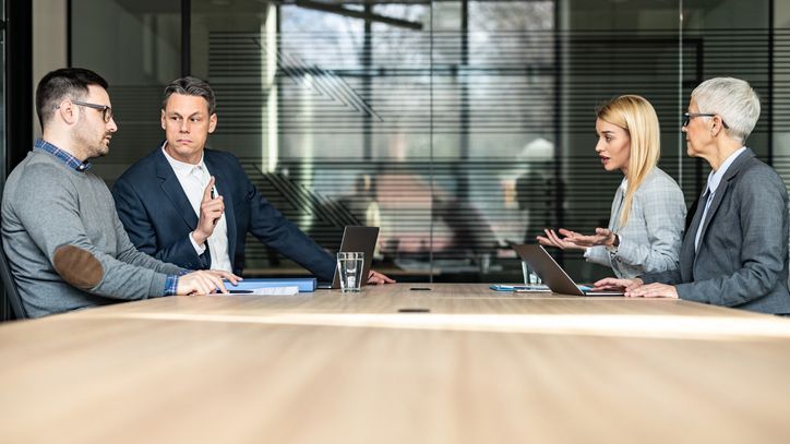 A divorcing couple meets with their attorneys.