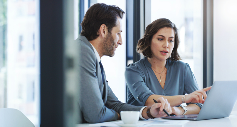 Financial advisors reviewing financial planning resources for clients.