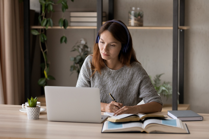 An investment adviser representative studying to maintain her registration and licensing.
