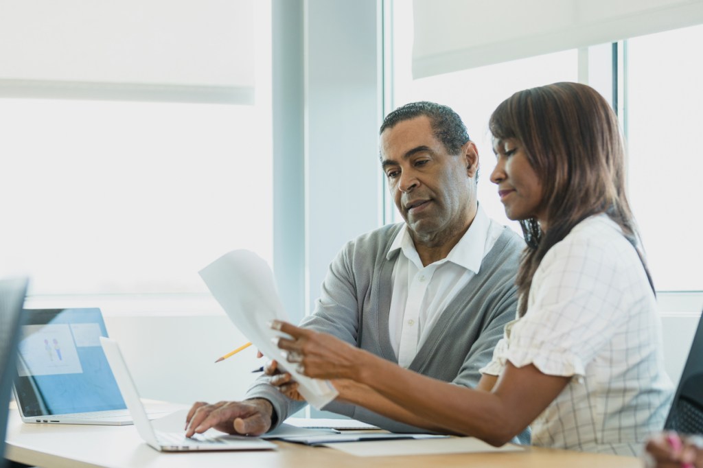An advisor going through a list of questions during a discovery meeting with a client.