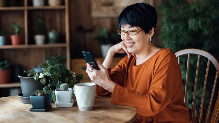 A woman who is still working looks over the terms of the health reimbursement arrange that her company offers.