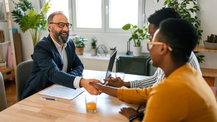A financial advisor meets with a pair of clients.