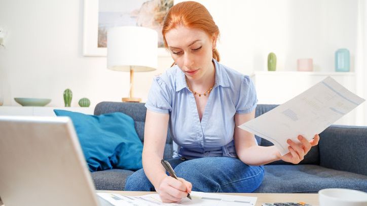 A woman who recently went through a divorce looks over student loans.