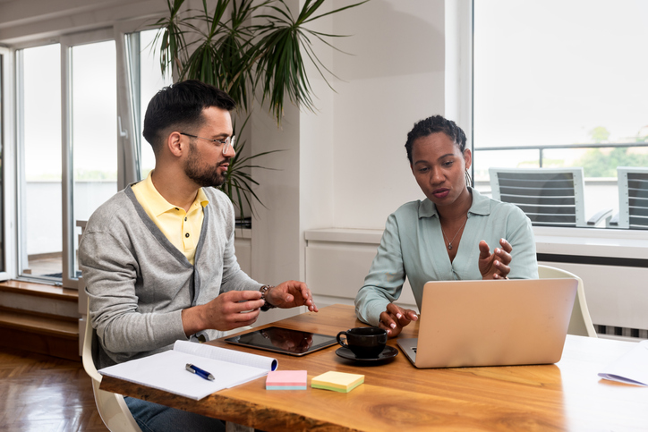 A self-employed worker meeting with a financial advisor to discuss health insurance premium deductions.