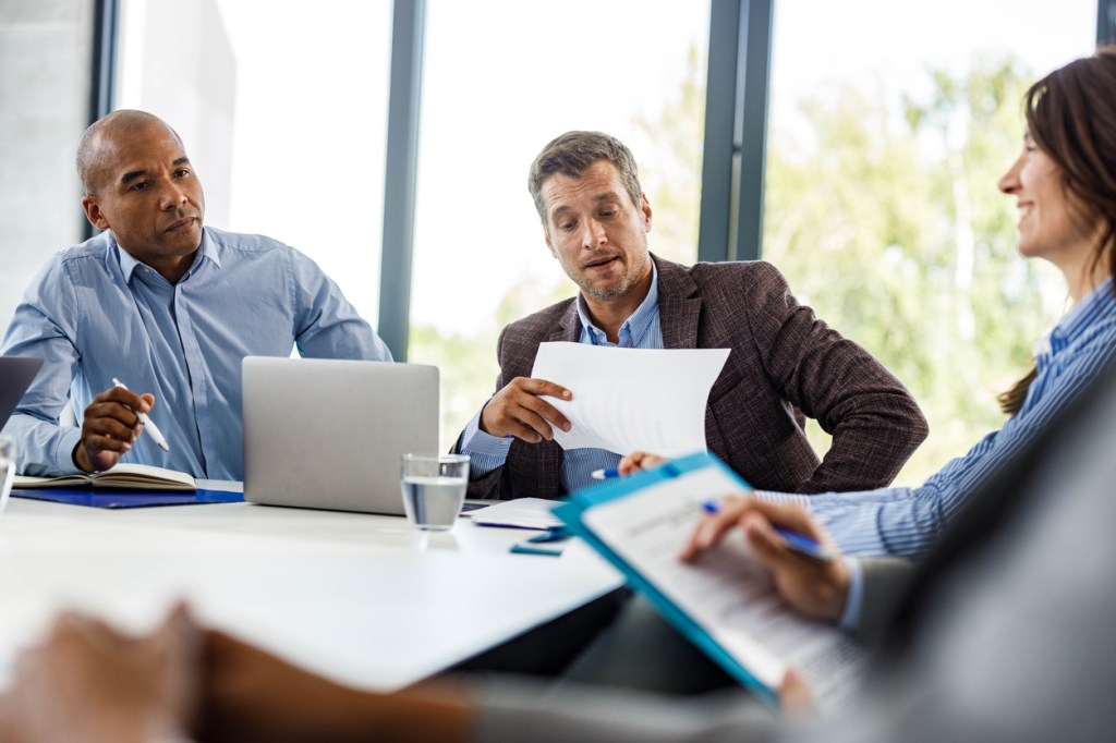 Advisors discussing the agenda for a client discovery meeting.