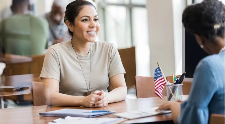 An active-duty service member speaks with a loan officer about getting a VA loan.